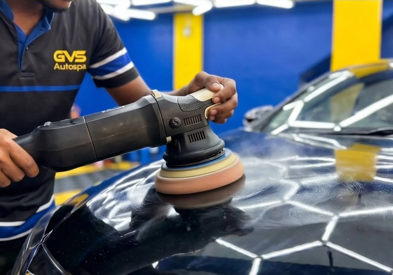 Machine polishing the bonnet of a black car